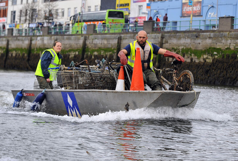 Clare Hayden and Mohammed Namoun of Meitheal Mara with the various items dumped in the River Lee. Picture: Eddie O'Hare
