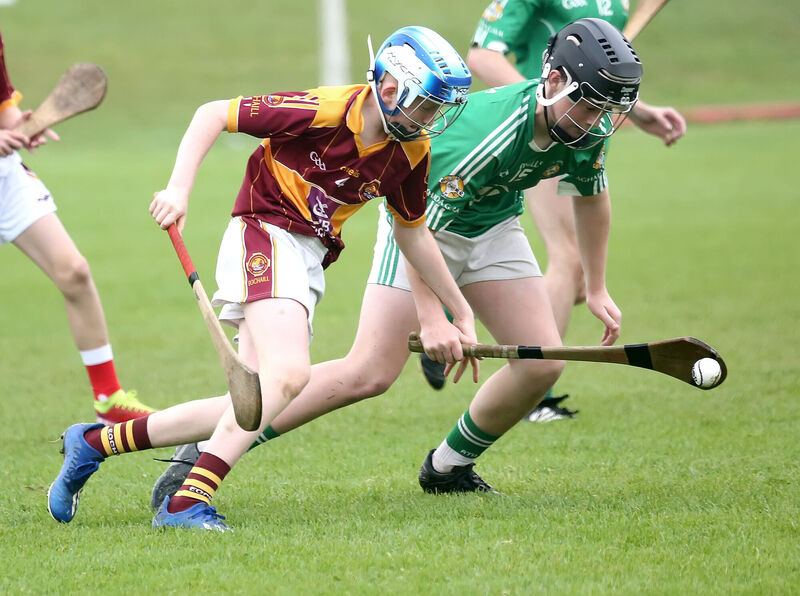 Samuel O'Driscoll, Aghada, gets the ball ahead of Gearoid Geary, Youghal, in the Rebel Óg U14 P2 hurling final, won by Aghada. Picture: John Hennessy