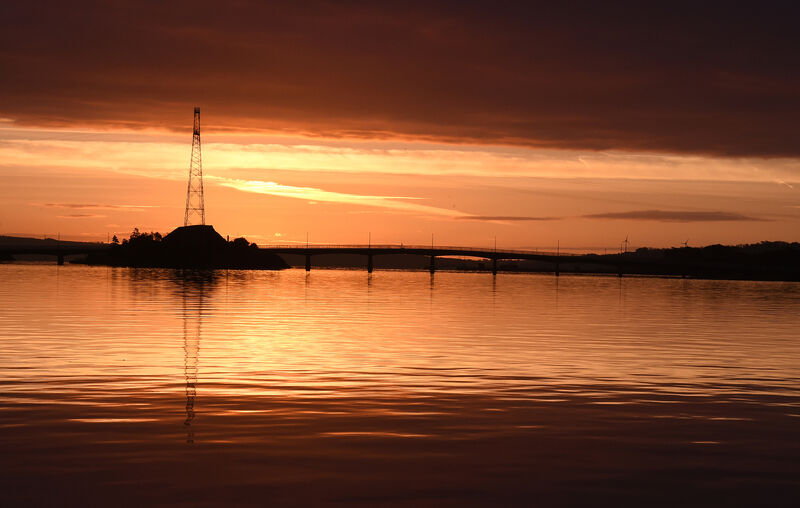 Sunrise over the still water of Cork Harbour, at Rocky Island, Cork Harbour is linked by a bridge to Haulbowline and Ringaskiddy. Sunrise over the still water of Cork Harbour, at Rocky Island, Cork Harbour is linked by a bridge to Haulbowline and Ringaskiddy.