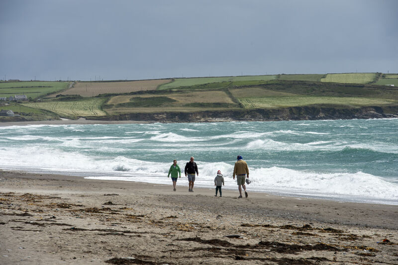 People taking an afternoon walk along the beach at Long Strand, Owenahincha, West Cork. Picture Dan Linehan  People taking an afternoon walk along the beach at Long Strand, Owenahincha, West Cork. Picture Dan Linehan