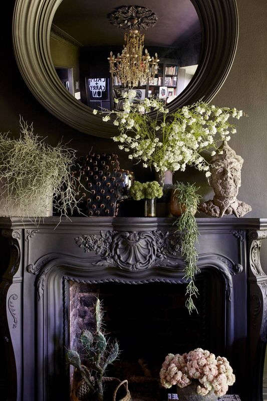 'Heavenly hearth' - A fireplace dressed to impress, with a mirror reflecting one of her statement chandeliers, makes a stunning focal point in one of the intimate spaces in Abigail Ahern's home. Picture: Graham Atkins-Hughes/PA.