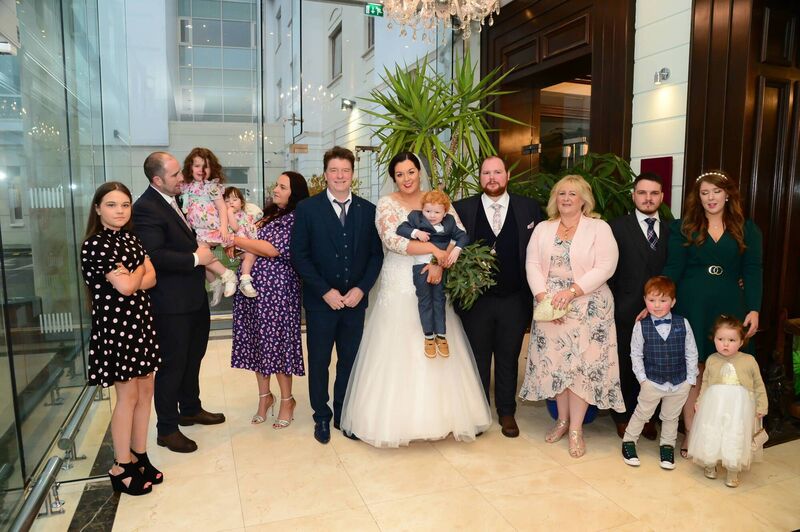 The happy couple with family members, who joined them for their special day. They had a small group of 23 family members due to Covid restrictions.