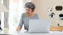 Senior woman checking bills