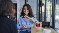 Two young woman speak in sign language
