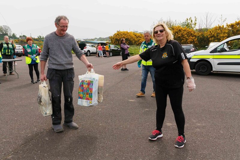 Ken Tyrrell dropping off food to Mary Newman of Glen Rovers Camogie Club.