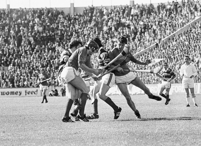 Action at a packed Páirc Uí Chaoimh in 1977, with referee Frank Murphy in the background.