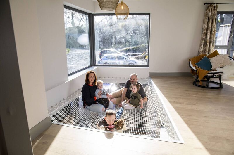 Rachel Hobbs pictured at home with husband Rob and their children Rocco, Indie and Forrest, on their net landing area. Picture: Clare Keogh Rachel Hobbs pictured at home with husband Rob and their children Rocco, Indie and Forrest, on their net landing area. Picture: Clare Keogh