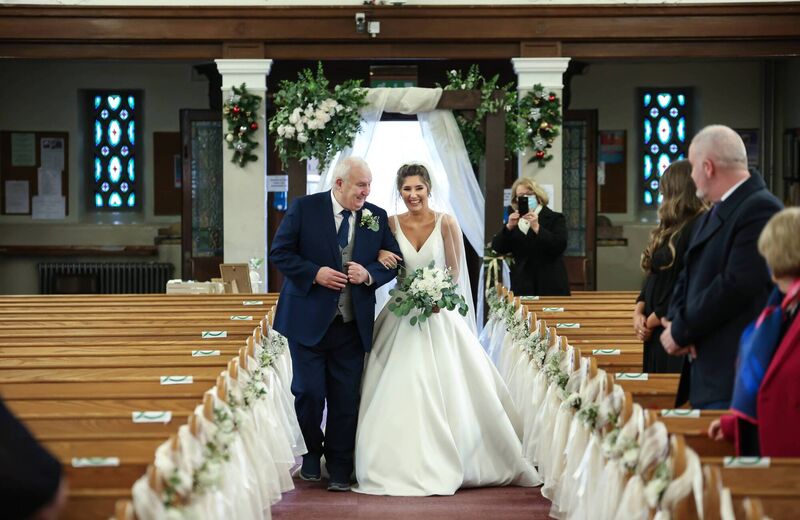 Catherine with her father, as he walked her down the aisle of the Sacred Heart Church. Catherine with her father, as he walked her down the aisle of the Sacred Heart Church.