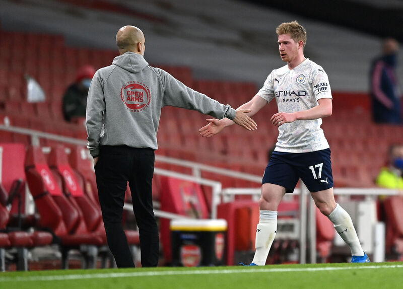 Manchester City's Kevin De Bruyne (right) is congratulated by manager Pep Guardiola after being substituted during the Premier League match at the Emirates Stadium, London.last weekend. City have the luxury of welcoming back such a great player from longterm injury, while still being 10 points ahead in the Premier League.	   Picture: Shaun Botterill/PA Wire.