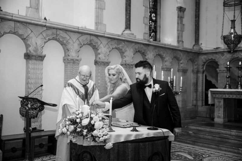 LIGHTING THE WAY: Michelle Condon and Duncan Campbell with Fr Cormac Bhreathnach at The Honan Chapel, UCC.