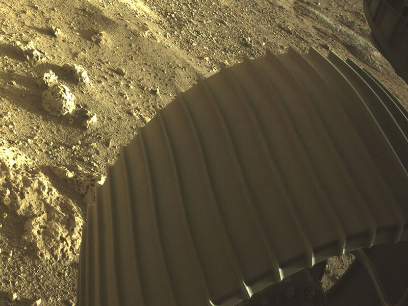 NASA handout high-resolution image showing one of the six wheels aboard NASA's Perseverance Mars rover after it touched down on Mars in February.
