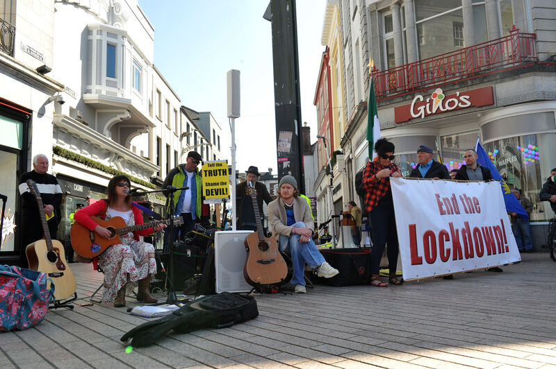Music and songs for the crowds on St Patrick's Street, Cork City for the peaceful Anti-Lockdown protest rally. Picture: Larry Cummins