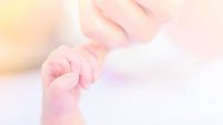 new born little hand holding mum finger in soft tone background