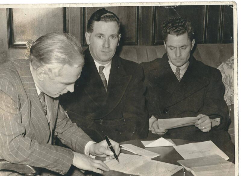 Raich Carter signing on the dotted line for Donie Forde and Dan Fitzgibbon.