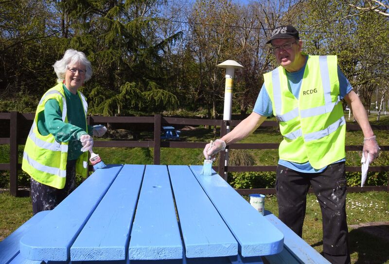 Helen and John Fox of Rochestown Community Development Group helping with the painting of picnic tables at Rochestown village green in Cork. Picture Denis Minihane.