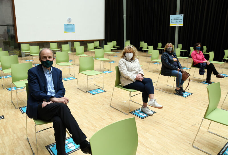 An Taoiseach, Micheál Martin, T.D., sitting in the observation area after getting the Covid-19 vaccine at City Hall, Cork, with (from second left) Hazel Murphy, Albert Road, Cork; Bernadette Buckley, Ballyphehane, Cork, and Frances Pinfield, Douglas, Cork.