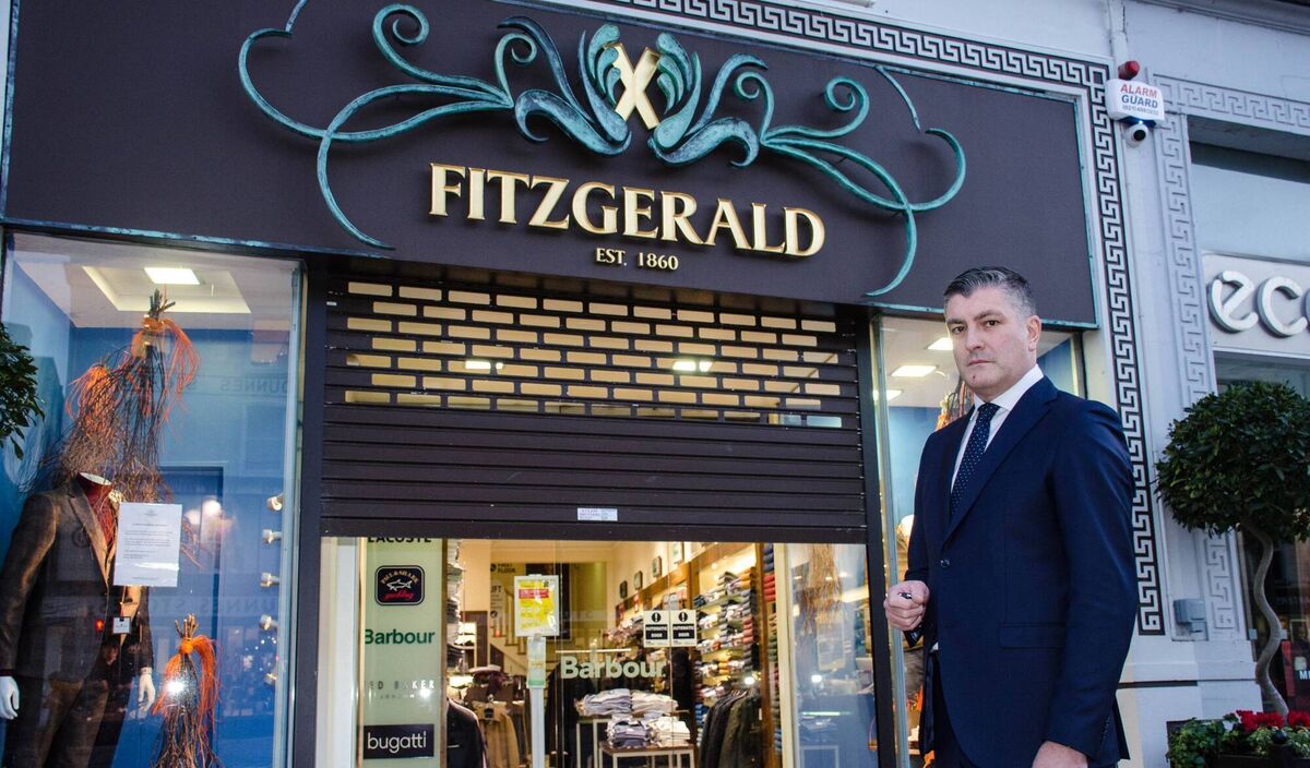 Eddie Mullins, managing director of Fitzgerald  Menswear on Patrick Street,  bringing down the shutters of his premises back in 2020 when Level 5 lockdown came into force. Picture: Howard Crowdy