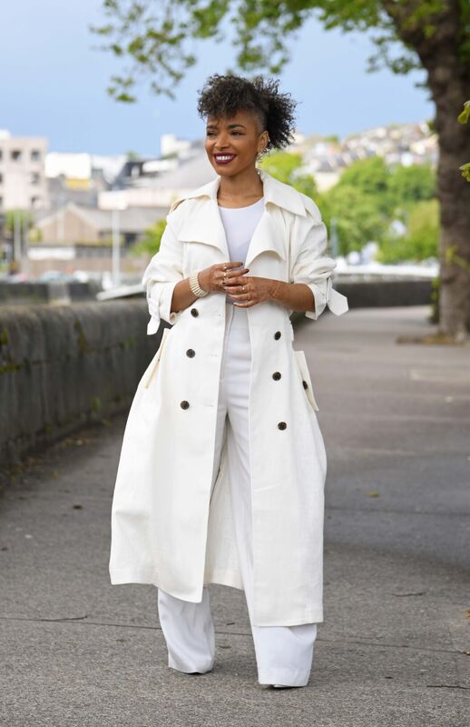 Andrea wears a white coat from H&amp;M and trousers from Zara.