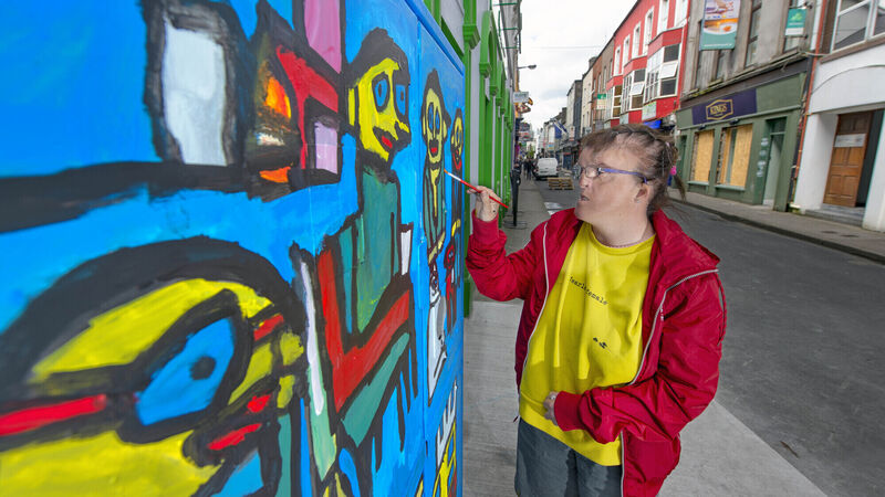 Dynamic female artist who is partially sighted creates bold images at speed Dynamic female artist who is partially sighted creates bold images at speed
