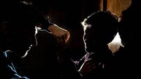 silhouette of two young guys in the dark place bully and fight conception