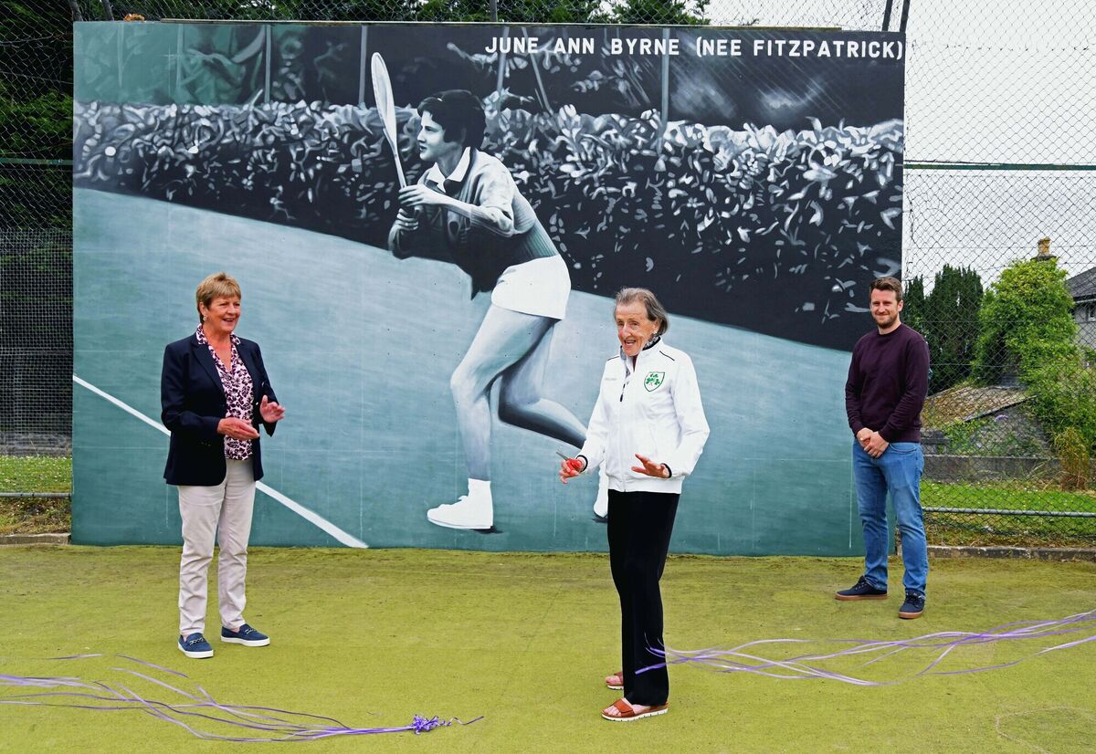 June Ann Byrne nee Fitzpatrick cutting the ribbon at the unveiling of a mural of herself to honour her at the club in the presence of Mercy Murphy, club president, and artist Jack Hickey, who painted the mural.
