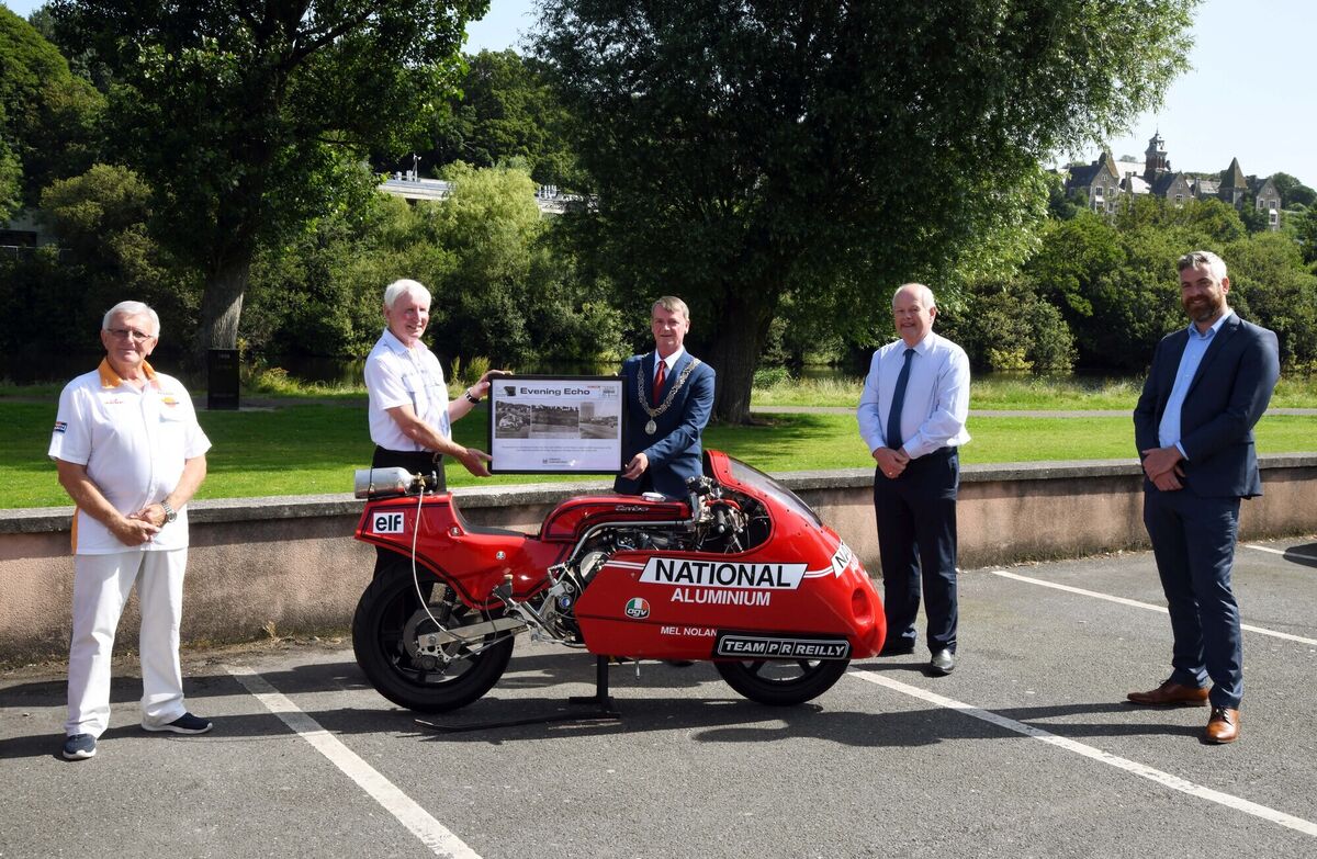 Cllr. Fergal Dennehy, presenting a framed copy of the front page of the Evening Echo from July 1981 to Mel Nolan and Denis Collins, team manager, (left) at the Carrigrohane (Straight) Road, Cork. Also present were David O'Brien, city librarian, and Christopher O'Sullivan, T.D. (right). Cllr. Fergal Dennehy, presenting a framed copy of the front page of the Evening Echo from July 1981 to Mel Nolan and Denis Collins, team manager, (left) at the Carrigrohane (Straight) Road, Cork. Also present were David O'Brien, city librarian, and Christopher O'Sullivan, T.D. (right).