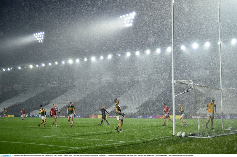 Kerry players Tadhg Morley and Peter Crowley watch as Luke Connolly points a free in torrential rain last winter. Picture: Brendan Moran/Sportsfile