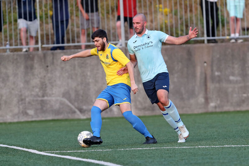  Darragh Buckley, Carrigaline Utd, tries to hold off Declan Cahill, Avondale Utd, in the  Munster Senior League Premier clash. Picture: Jim Coughlan.