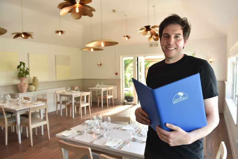  Daniel Horgan with the menu at the Man Friday restaurant in Kinsale, Cork as they prepare to open for indoor dining. Picture Dan Linehan