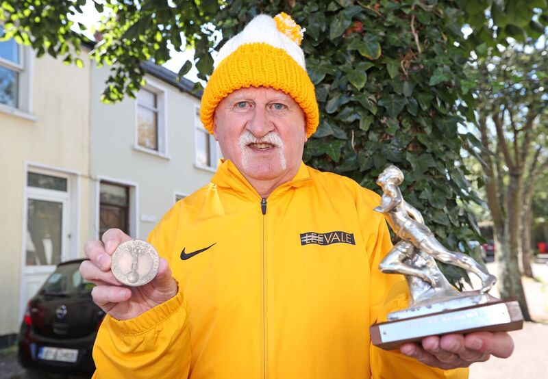 Donie Walsh, Leevale AC, with his World Cross Country Silver Team Medal from 1979 and his first Winning trophy from the half marathon in Delaware, 1971. Donie Walsh, Leevale AC, with his World Cross Country Silver Team Medal from 1979 and his first Winning trophy from the half marathon in Delaware, 1971.