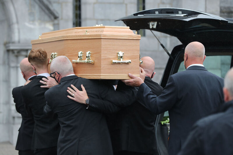 Pallbearers carry the coffin from the hearse at the funeral of Mark Wills at the Church of Mary and St John in Ballincollig. Picture: Niall Carson/PA Wire