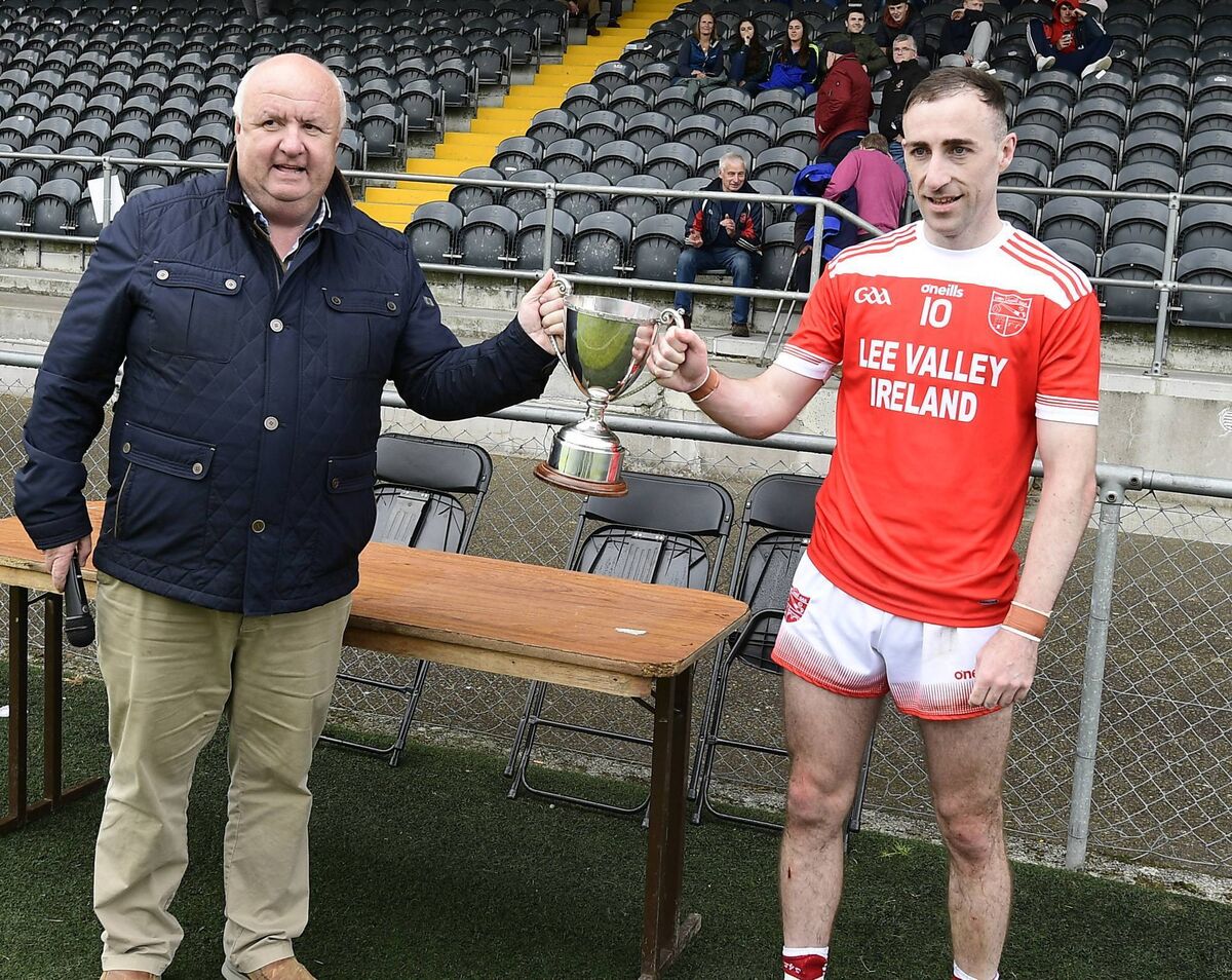 Iveleary captain Brian Cronin receives the cup from Noel O'Callaghan, County Development Officer. Picture: John Tarrant