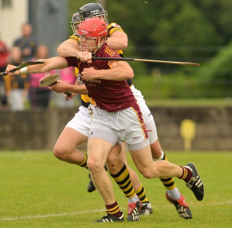 Youghal forward Bill Cooper tackled by Na Piarsaigh defender John Gardiner. Picture: Des Barry.