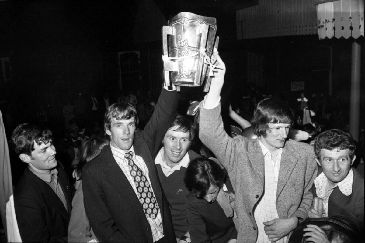 Cork hurling team arrive back in Cork after All-Ireland victory over Wexford in 1976. Holding the cup are Ray Cummins and Eamonn O'Donoghue.