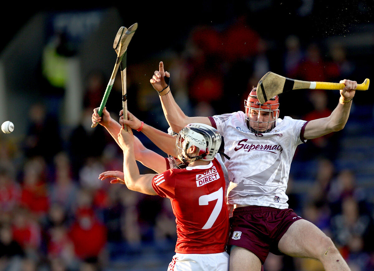 Galway's Michéal Power and Oisín Lohan with Timmy Wilk of Cork battling under a puck-out. Picture: INPHO/James Crombie
