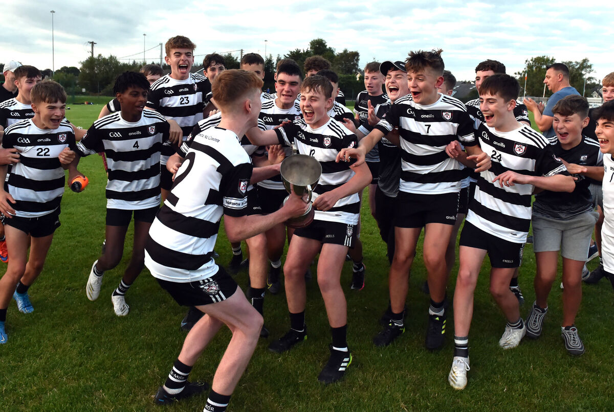 Midleton celebrate their win with the hero of the hour - number 23 Sean McSharry -  in the background. Picture: Eddie O'Hare