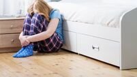 sad teenager girl with scales on floor