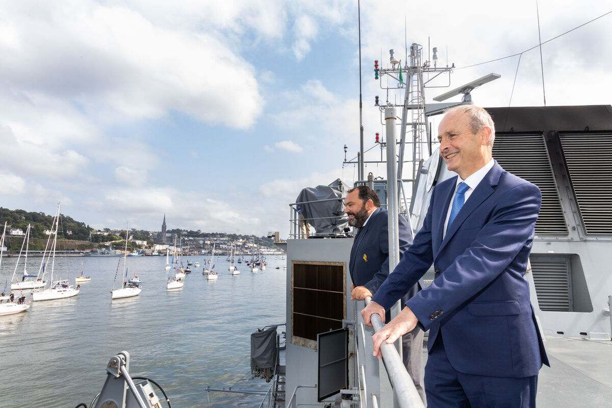 An Taoiseach Micheal Martin TD and Colin Morehead, Admiral RCYC wave to sailors taking part in the Tricentenary Maritime Parade for Royal Cork Yacht Club Tricentenary. Pic Darragh Kane
