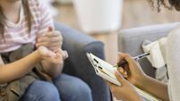 Mental health professional takes notes during session