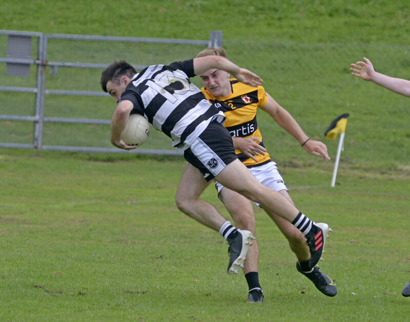 Gary Murphy for Castletownbere shipping a tackle from Greg Healy for Na Piarsaigh, for which he was black carded. Picture: Denis Boyle