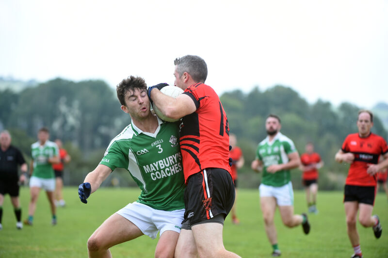  Full-back Sean Daly, Dohenys tries to stop full-forward Leonard Ó Conchúir, Ballingeary. Picture: Larry Cummins