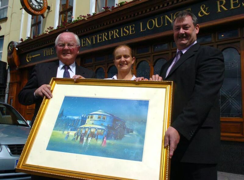 Billa O'Connell handing over a picture of the Old Opera house which was presented to him from the Flying Enterprise complex, to Pat Coughlan, manager The Lough credit union, with Fionnula O'Shea, proprietor Flying Enterprise. /Picture; Eddie O'Hare Billa O'Connell handing over a picture of the Old Opera house which was presented to him from the Flying Enterprise complex, to Pat Coughlan, manager The Lough credit union, with Fionnula O'Shea, proprietor Flying Enterprise. /Picture; Eddie O'Hare