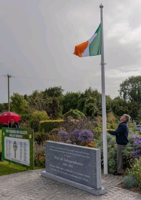 Committee member Jerry O'Brien raising the national flag.