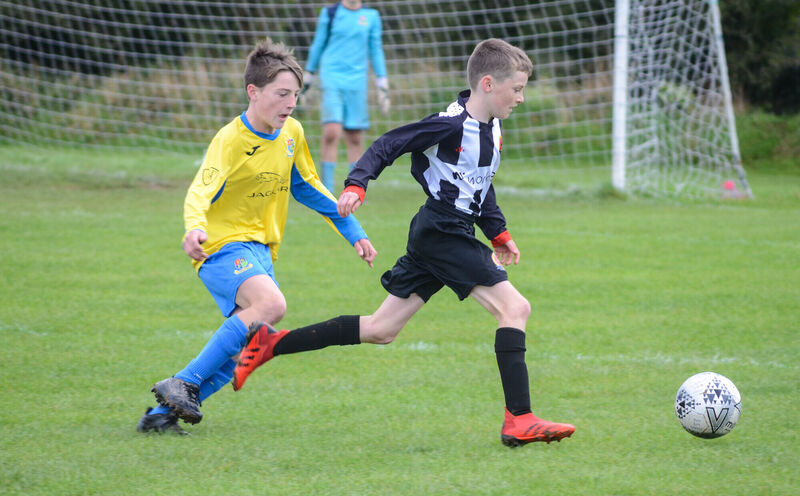 Midleton's Alex Wilson pulls away from Carrigaline's Eoghan Ahern. Picture: Howard Crowdy Midleton's Alex Wilson pulls away from Carrigaline's Eoghan Ahern. Picture: Howard Crowdy