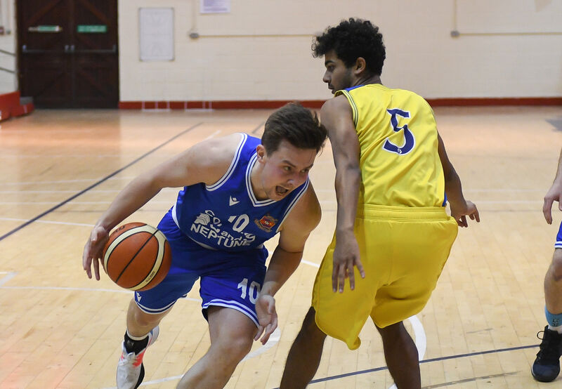 Neptune's Roy Downey drives past DCU Saints' Marcus Black, during their Men's Super League clash at Neptune Stadium. Picture: David Keane Neptune's Roy Downey drives past DCU Saints' Marcus Black, during their Men's Super League clash at Neptune Stadium. Picture: David Keane