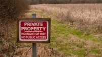 red wooden private property sign farm land no right of way no public access