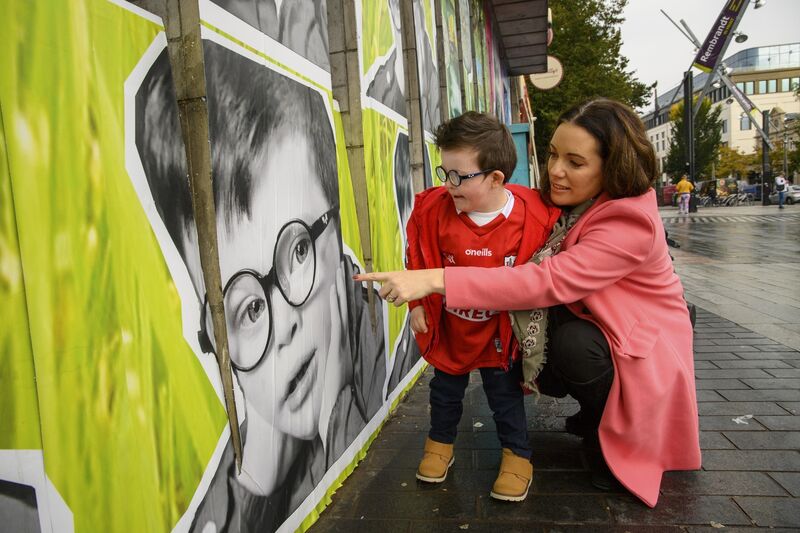 Pictured is four-year-old Harry Brassel and mother Orla, from Cork city by his portrait, part of The Upside Mural at Cork City Library marking Down Syndrome Ireland's 50th Anniversary. Pictured is four-year-old Harry Brassel and mother Orla, from Cork city by his portrait, part of The Upside Mural at Cork City Library marking Down Syndrome Ireland's 50th Anniversary.