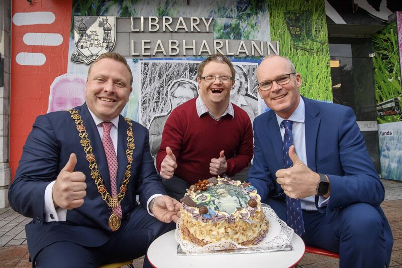 Pictured Lord Mayor of Cork Cllr Colm Kelleher; John Sweetnam who celebrated his 51st birthday with Minister Simon Coveney by John's portrait, part of The Upside Mural at Cork City Library marking Down Syndrome Ireland's 50th Anniversary. Picture: Daragh Mc Sweeney/Provision Pictured Lord Mayor of Cork Cllr Colm Kelleher; John Sweetnam who celebrated his 51st birthday with Minister Simon Coveney by John's portrait, part of The Upside Mural at Cork City Library marking Down Syndrome Ireland's 50th Anniversary. Picture: Daragh Mc Sweeney/Provision