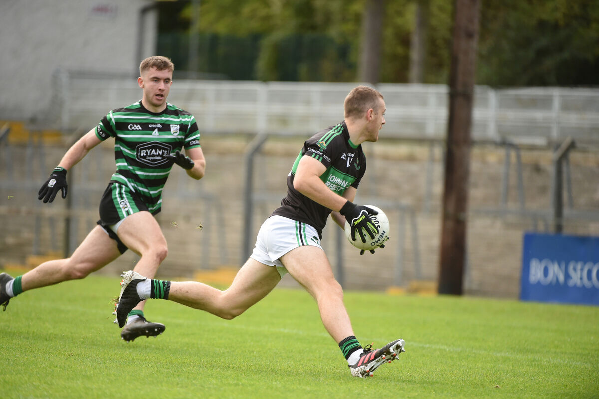 Conor Horgan, Nemo Rangers, with possession as Douglas defender Luke McGrath closes in. Pic: Larry Cummins. Conor Horgan, Nemo Rangers, with possession as Douglas defender Luke McGrath closes in. Pic: Larry Cummins.