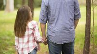 Father, daughter hold hands outdoors. Parent, child. Love, affection.